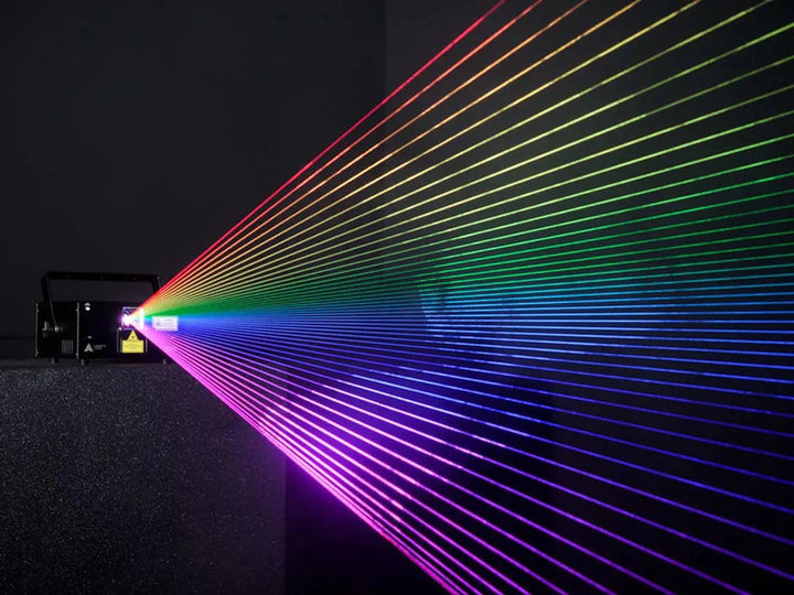 Unity Raw series laser casting a wide fan of rainbow beams through haze
